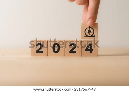 Creative idea, solution and innovation in 2024 concept. Idea generation for business development. Wooden cube blocks with 2024 text and light bulb and cycle icons on clean background and copy space.