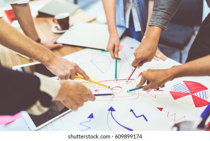 Creative idea teamwork concept. Group of multiethnic diverse team, business partner, or college students in project meeting at modern office. Five people pointing at lightbulb drawings. - Shutterstock ID 609899174