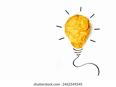 Creative ideas and Inspiration concepts. Crumpled colored paper in shape of yellow light bulb isolated on white background with copy space - Powered by Shutterstock