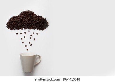 
a creative image of a cloud and raindrops made from coffee beans and a white cup without a pattern. concept of coffee in any weather, coffee is a good idea