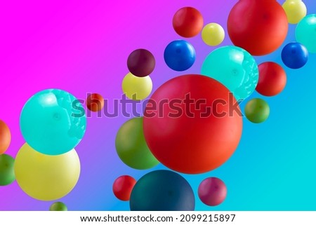 Creative image of colorful balloons floating in the studio. Abstract multicolored spheres on blue and pink backgrounds. Abstraction of colors.