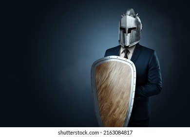 Creative image, a man in a modern suit of a businessman, a knight's helmet on his head, armor. The concept of a modern hero, overcoming difficulties, a crisis, a good manager. magazine style. - Shutterstock ID 2163084817