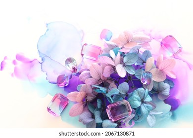 Creative Image Of Pink And Purple Hydrangea Flowers On Artistic Ink Background. Top View With Copy Space