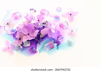 Creative Image Of Pink And Purple Hydrangea Flowers On Artistic Ink Background. Top View With Copy Space