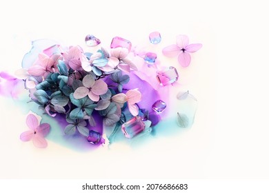 Creative Image Of Pink And Purple Hydrangea Flowers On Artistic Ink Background. Top View With Copy Space