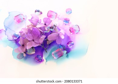 Creative Image Of Pink And Purple Hydrangea Flowers On Artistic Ink Background. Top View With Copy Space