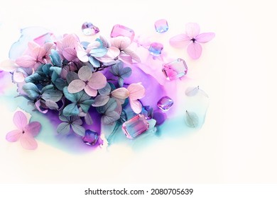 Creative Image Of Pink And Purple Hydrangea Flowers On Artistic Ink Background. Top View With Copy Space