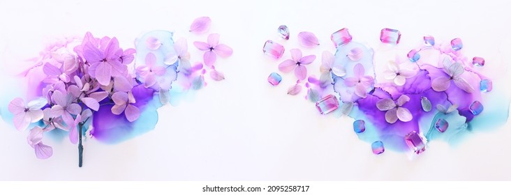 Creative Image Of Pink And Purple Hydrangea Flowers On Artistic Ink Background. Top View With Copy Space