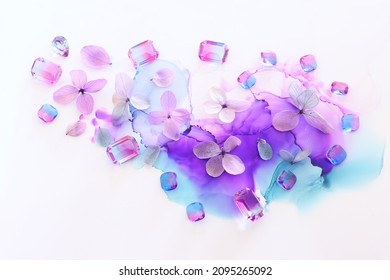 Creative Image Of Pink And Purple Hydrangea Flowers On Artistic Ink Background. Top View With Copy Space