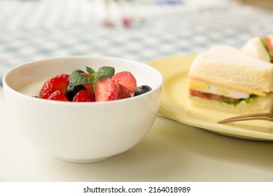Creative image. Strawberries, blueberries, berries, flavored yogurt drinks, fast food sandwiches, family, restaurant, breakfast - stock photo