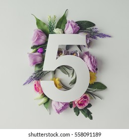 Creative Layout With Colorful Flowers, Leaves And Number Five. Anniversary Concept.Flat Lay.