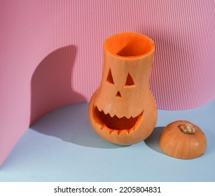 Creative Layout Composition Of Halloween Pumpkin On Blue Pink Background With Shadow. Face With Sinister Smile. Trick Or Treat