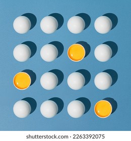 Creative layout composition made with made of eggs on blue background. Minimal concept of eastar. Creative art, minimal aesthetics. Flat lay.