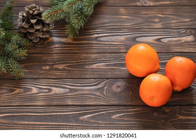 Creative layout frame made of Christmas fir branches, pine cones on wooden background. Xmas and New Year theme. Flat lay, top view