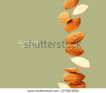 Creative layout made of almond on the green background. Flat lay. Food concept. Macro concept. 