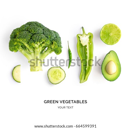 Creative layout made of avocado, lime, broccoli, green pepper, cucumber, chilli pepper and zucchini. Flat lay. Food concept. Green vegetables isolated on white background.