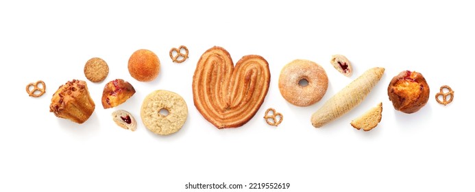 Creative layout made of breads, sweets, donuts, muffins and buns on the white background. Flat lay. Food concept. Pastry on the white.