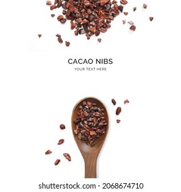Creative layout made of cacao nibs and wood spoon on a white background. Top view.  