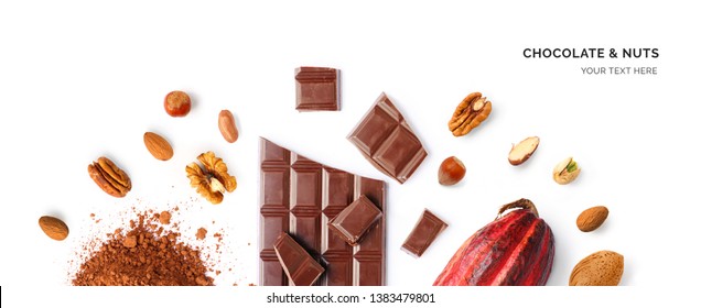 Creative Layout Made Of Chocolate, Walnut, Hazelnut, Almonds, Cacao Fruit And Cacao Powder On The White Background. Flat Lay. Food Concept. 