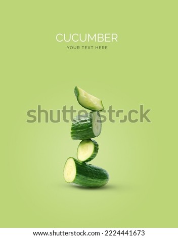 Creative layout made of cucumber on the green background. Flat lay. Food concept.