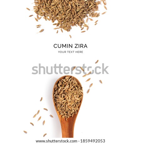 Creative layout made of cumin seeds and wood spoon on a white background. Top view.  