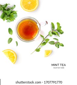 Creative layout made of a cup of mint tea and lemon on a white background. Top view.