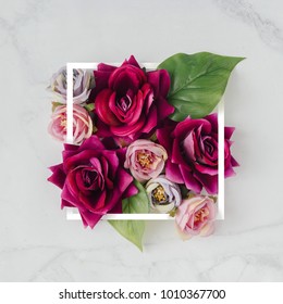 Creative layout made with flowers and white frame. Spring minimal concept. Nature background.