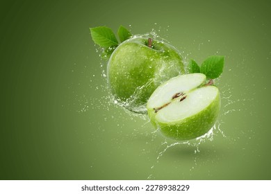 Creative layout made form whole and slice green apple and water splashing on a green background.