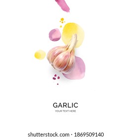 Creative layout made of garlic with watercolor spots on the white background. Flat lay. Food concept.