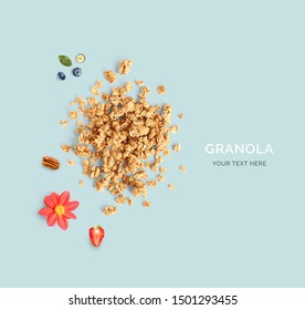 Creative layout made of granola, strawberry, blueberry and flowers. Flat lay. Food concept. Macro  concept.