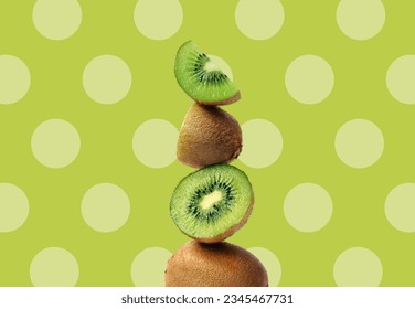 Creative layout made of green kiwi on the green background with dots. Flat lay. Food concept. Macro  concept.
