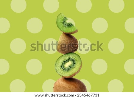 Creative layout made of green kiwi on the green background with dots. Flat lay. Food concept. Macro  concept.