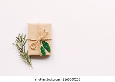 Creative Layout Made Of Green Leaves With Diy Gift Box On White Background. Flat Lay. Nature Concept