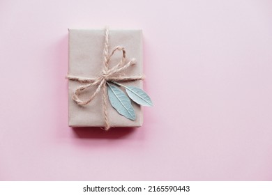 Creative Layout Made Of Green Leaves With Diy Gift Box On Pink Background. Flat Lay. Nature Concept