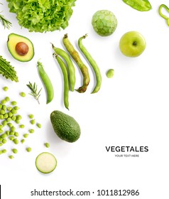 Creative layout made of green vegetables and fruits. Flat lay. Food concept. Avocado, broad bean, green peas, green apple, cherimoya, rosemary, zucchini and green lettuce on the white background.