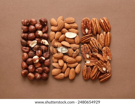 Creative layout made of hazelnut, almond, pecan nuts. Flat lay. Food concept. Nut pattern concept. Macro image.