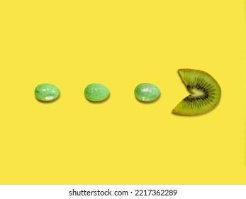 Creative Layout Made Of Kiwi Fruit Eating Green Easter Eggs Against Yellow Background. Original Lemon Decoration. Fruit Concept. Minimal Summer Design. Creative Easter Idea.