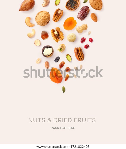 Creative layout made of macadamia, hazelnuts,\
walnut, cashew, sunflower seeds, peanut, almond, dates, pecan, fig,\
pumpkin seeds, pistachio, raisin,  cranberry on the beige\
background. Food\
concept.