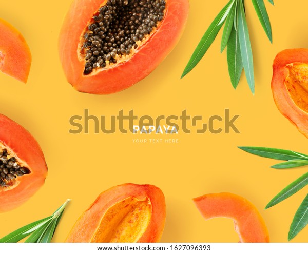 Creative layout made of papaya and\
leaves. Flat lay. Food concept. Papaya on yellow\
background.