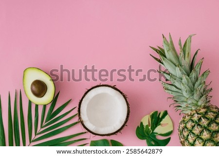 Creative layout made with pineapple, coconut, avocado and green tropical leaves on light pink background. Summer tropical fruits and leaves idea. Minimal food concept. Exotic flat lay, top view.