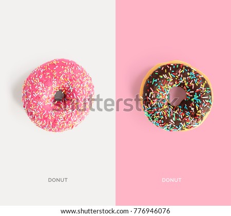 Creative layout made of pink and chocolate donuts. Flat lay. Food concept. Macro  concept.
