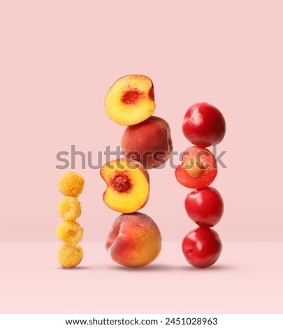Creative layout made of plum, peach and raspberry on the pink background. Food concept. Macro concept.