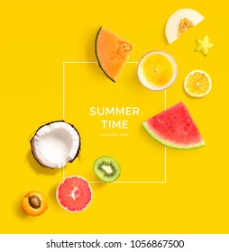 Creative layout made of summer fruits.  Tropical flat lay. Food concept. Melon, coconut, watermelon, kiwi, apricot, lemon and orange juice on yellow background.