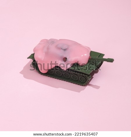 Creative layout, military tank with slime on pink background with shadow. Visual trend. Fresh idea. Concept pop. No war