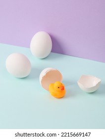 Creative Layout. Rubber Duck With Eggshell On Two Tone Pastel Background. Conceptual Pop. Minimal Still Life.