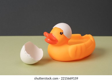 Creative Layout. Rubber Duck With Eggshell On Two Tone Background. Conceptual Pop. Minimal Still Life.