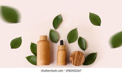 Creative Layout From The Wooden Cosmetics Containers With Fresh Green Leafs Around.Pretty Pastel Colors,natural Materials.Organic Concept.Large Banner With Negative Space.