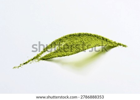 Creative leaf shape smear of bright green matcha green tea powder on white background