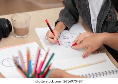 Creative Learning and Artistic Expression. A child drawing with colored pencils on paper, showcasing creativity.