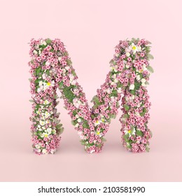 Creative letter M concept made of fresh Spring wedding flowers. Flower font concept on pastel pink background.